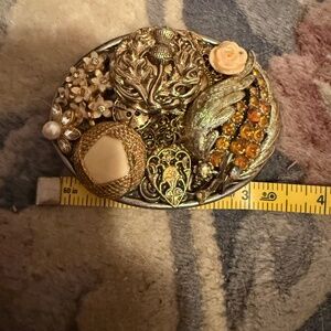 Gold tones for this blinged out belt buckle 3 1/2 x 2/1/2, fits onto a 1 1/2